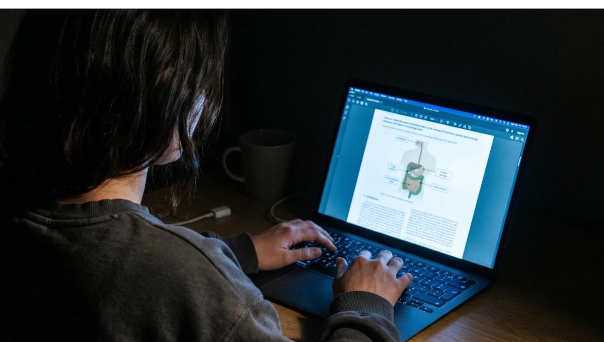 Woman researching on a laptop late at night